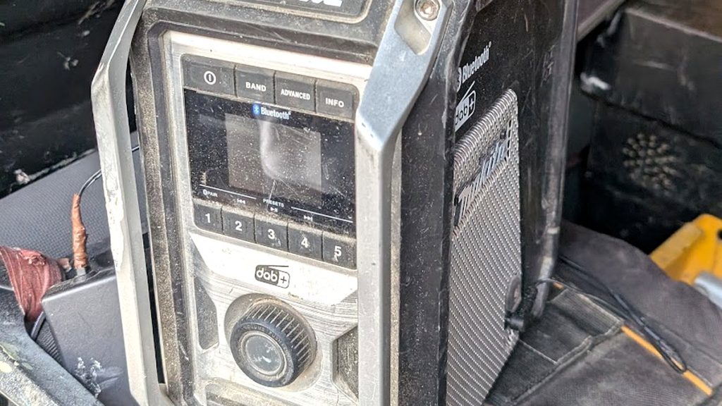 Site radio covered in dust in the back of a van, showing the conditions IP ratings describe