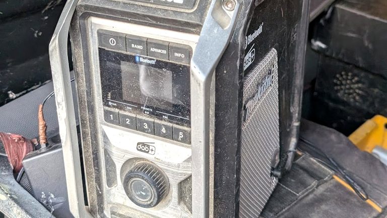 Site radio covered in dust in the back of a van, showing the conditions IP ratings describe