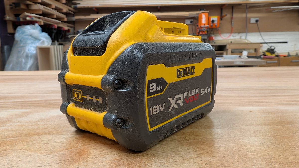 A DeWalt 9.0Ah FlexVolt pack with its three-bar charge indicator lit