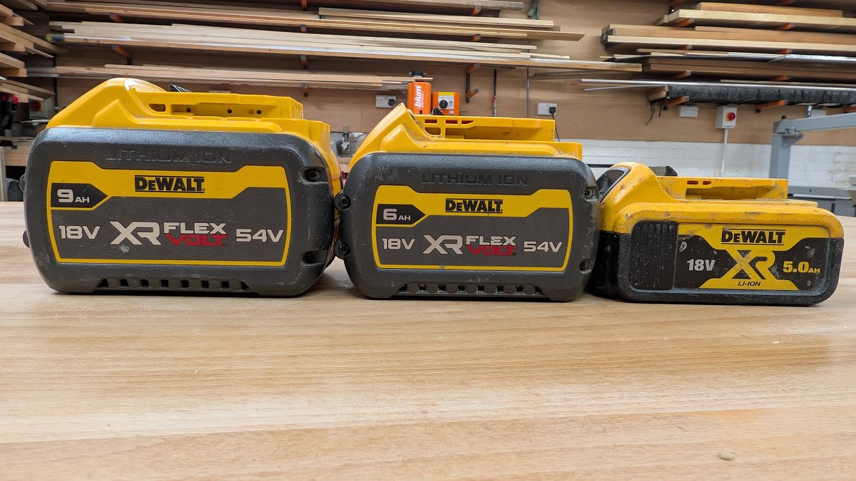 A 9.0Ah and a 6.0Ah DeWalt FlexVolt pack beside a 5.0Ah XR pack, showing the size difference