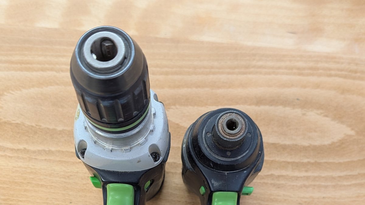 Looking down the noses of a combi drill and an impact driver, showing the three-jaw chuck beside the hex socket